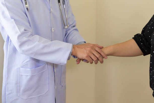 Dentist shaking hands with a patient
